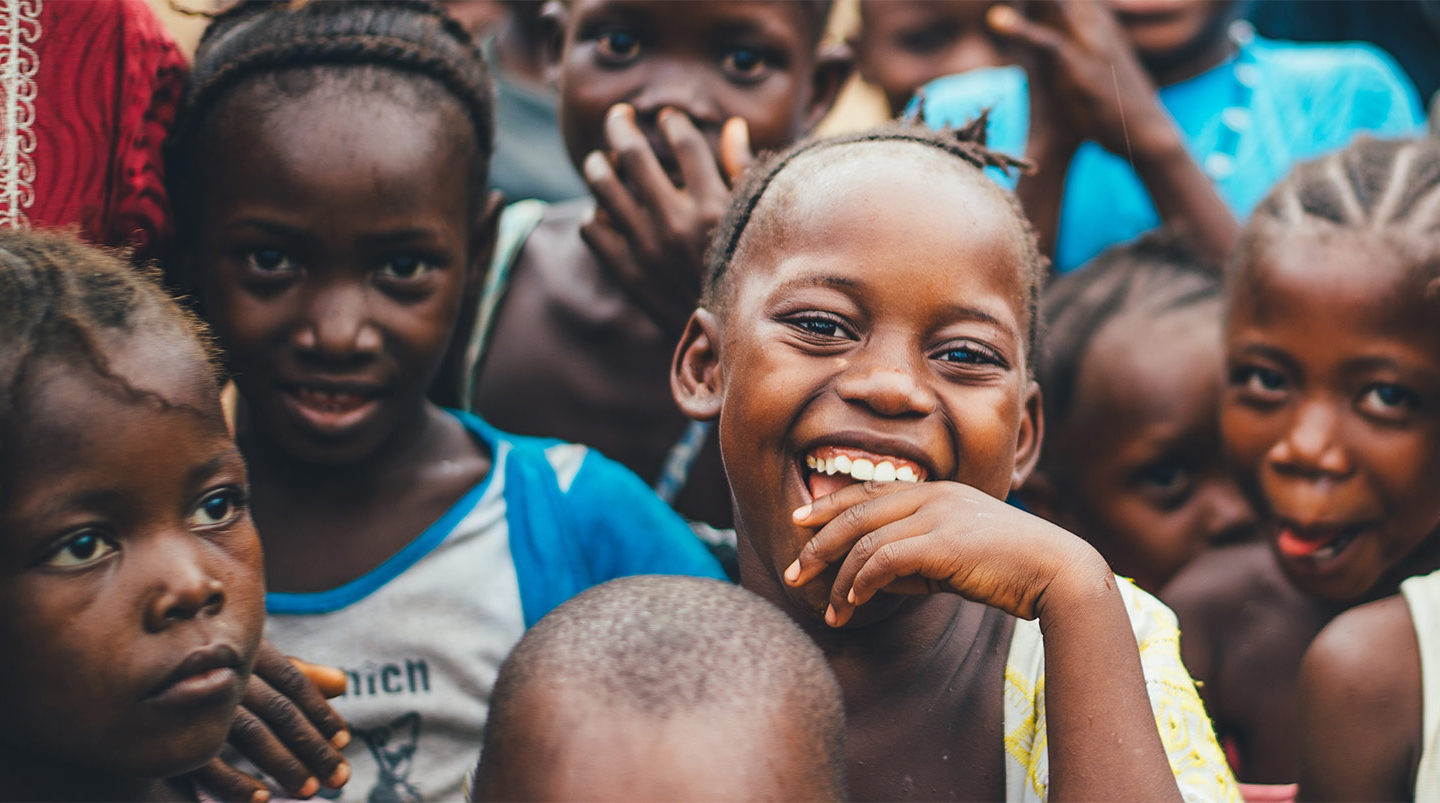 children standing in a group and smiling