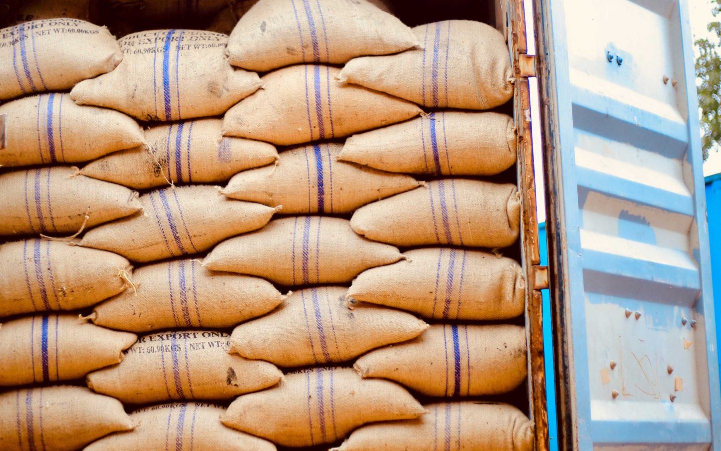 a truck loaded with sacks of coffee beans